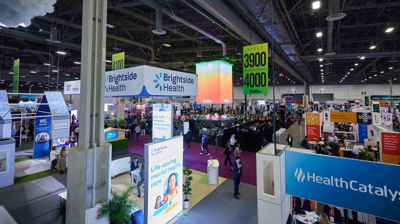 A Busy Exhibit Hall With A View Of The Sky Stage